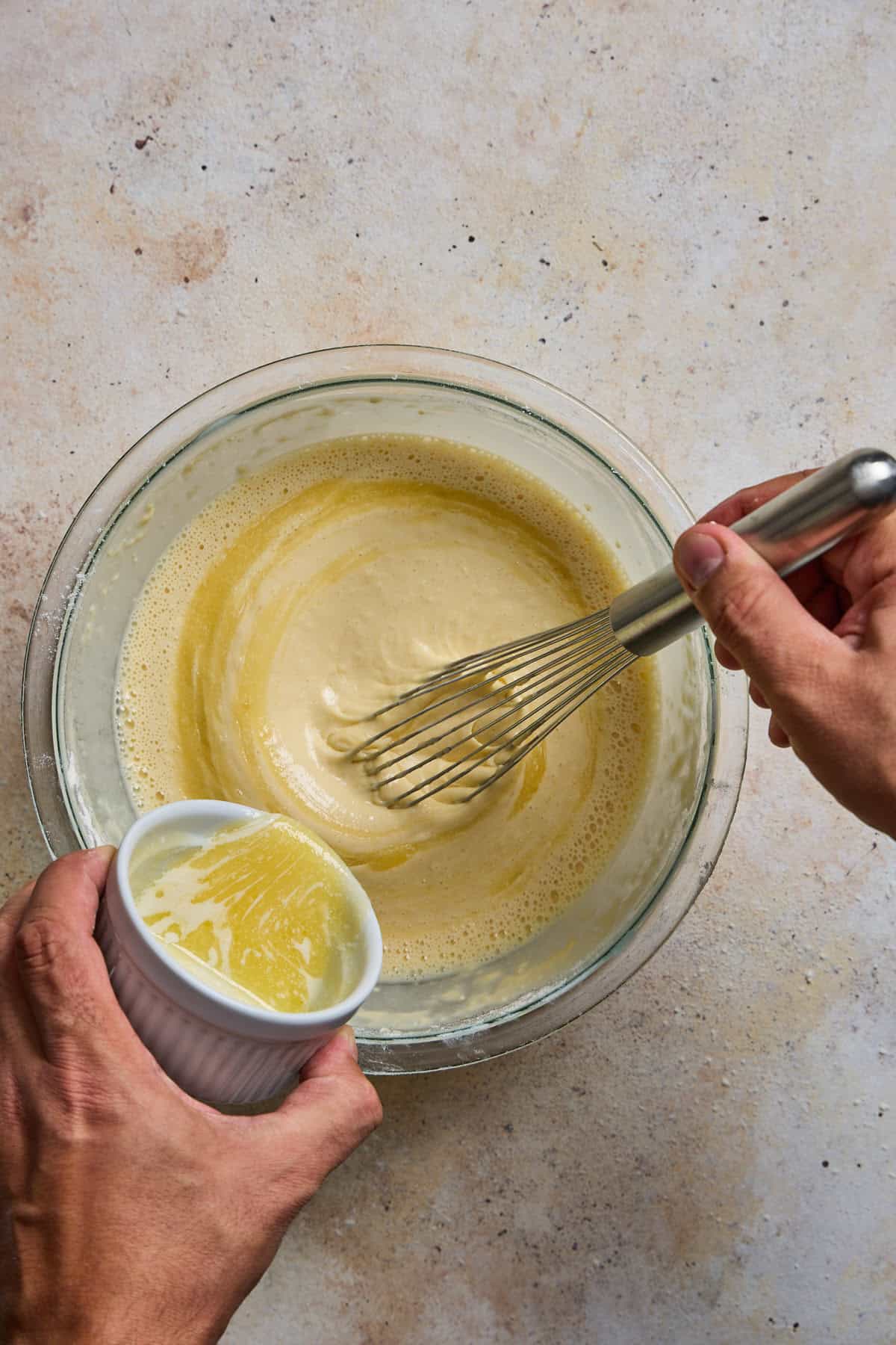 butter being whisked into crepe batter