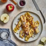 a plate with stuffed apple cremes covered in caramel and powdered sugar