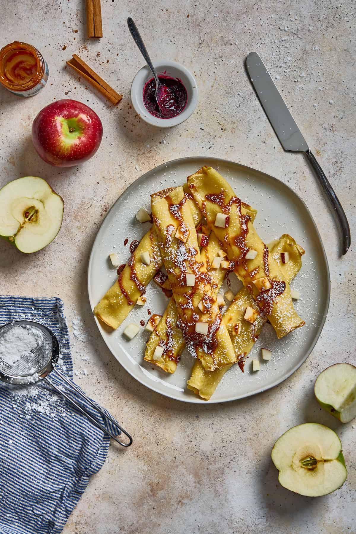 plate of crepes with apples and caramel