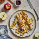 a plate of ricotta and apple crepes with powdered sugar