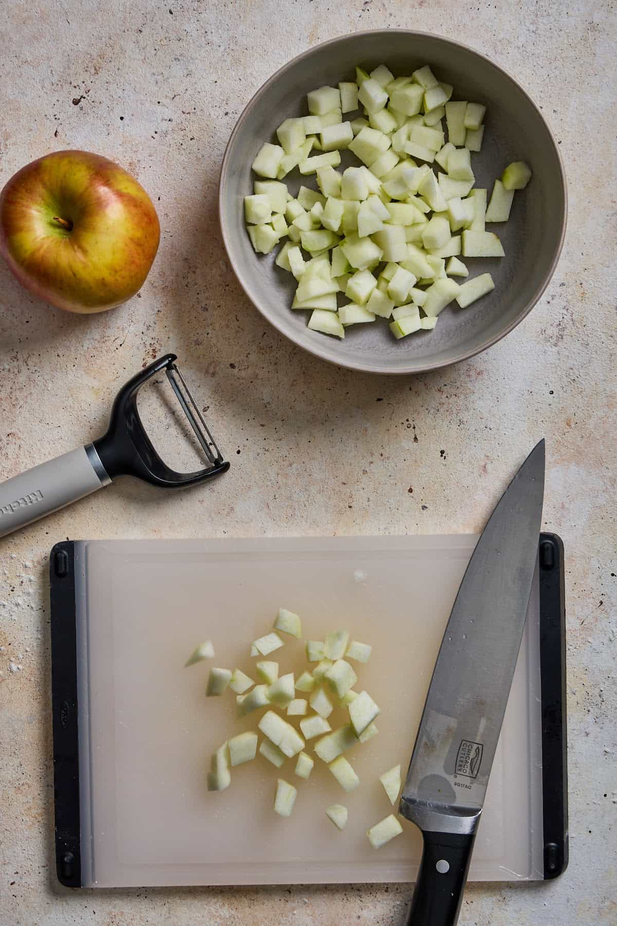 apple being chopped on small cutting board