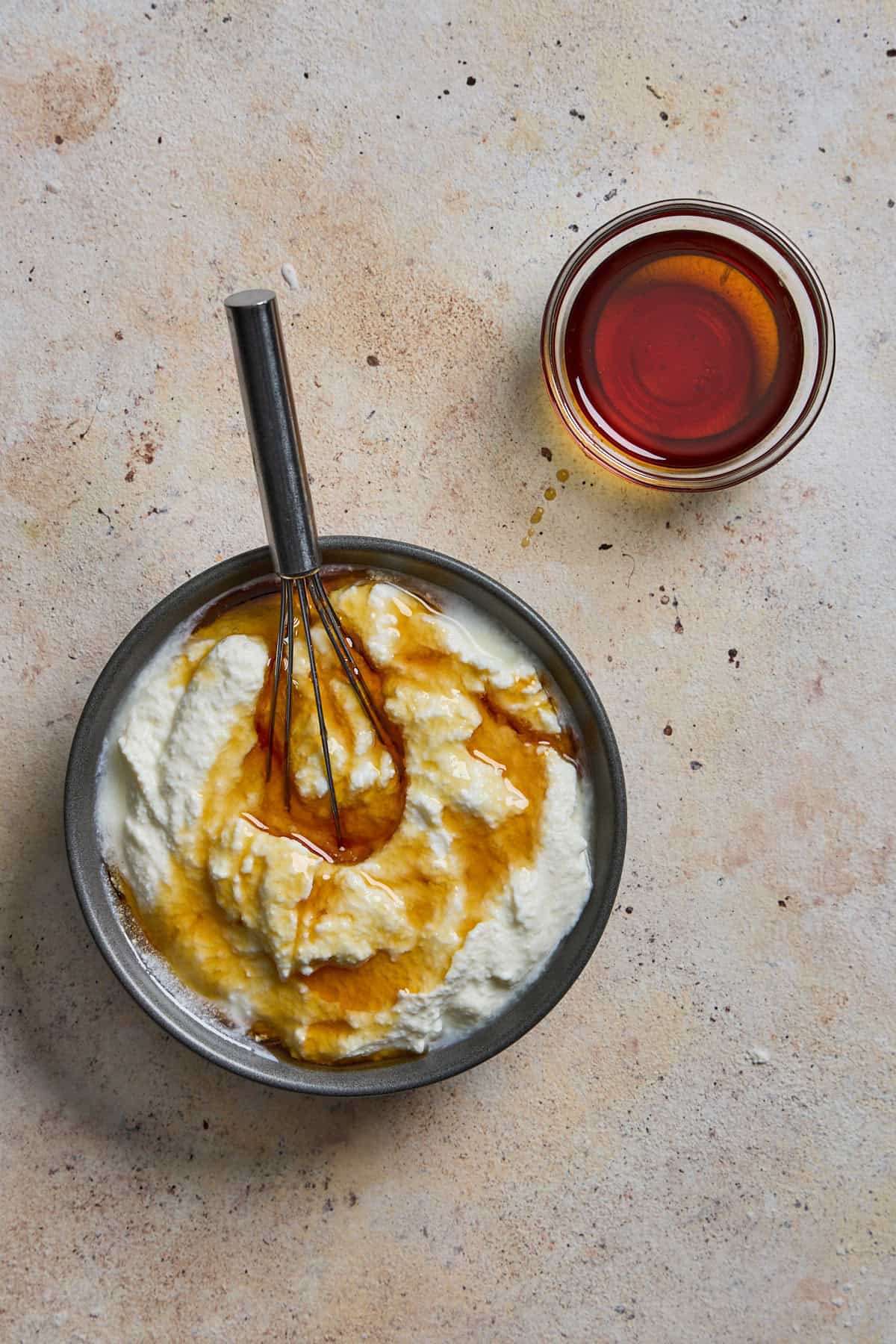 maple syrup being whisked into ricotta cheese