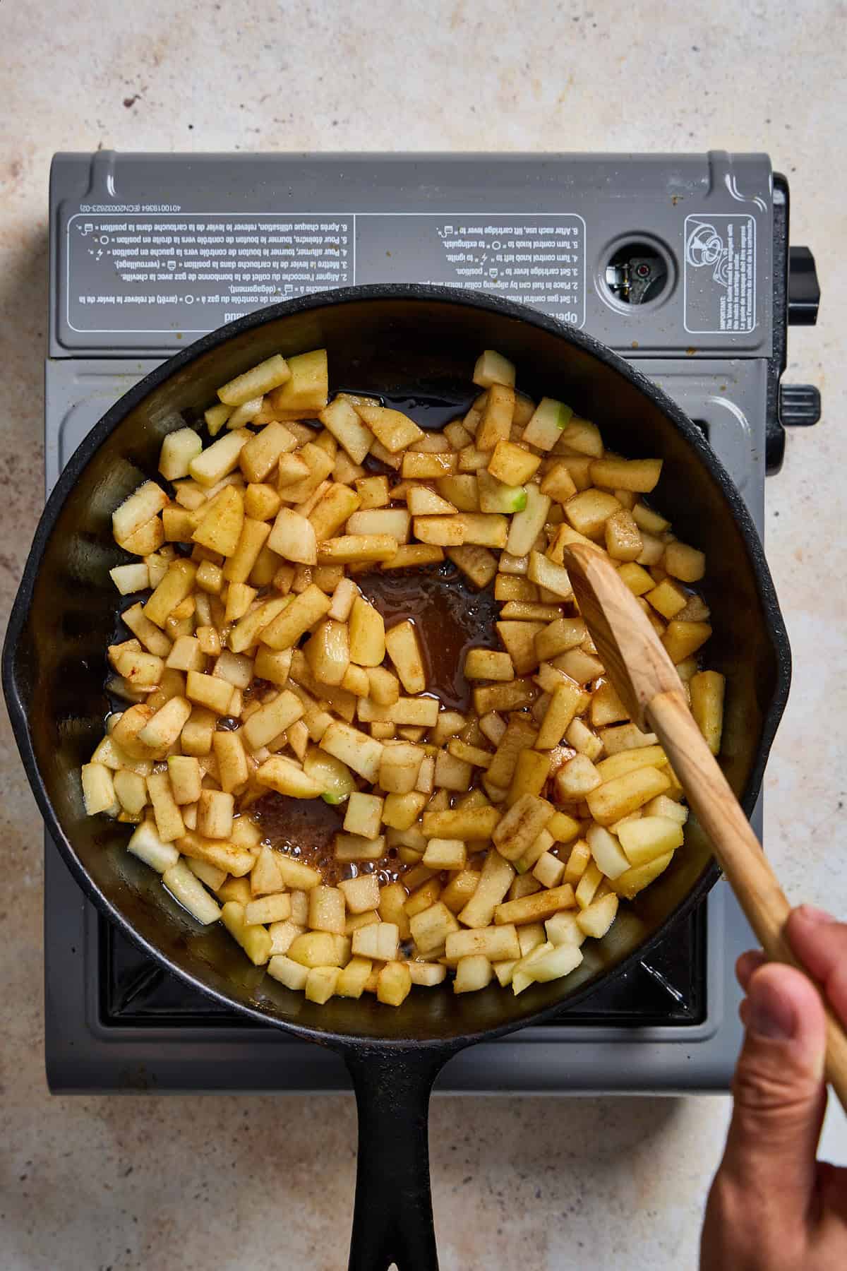 apples sauteeing in a cast iron pan