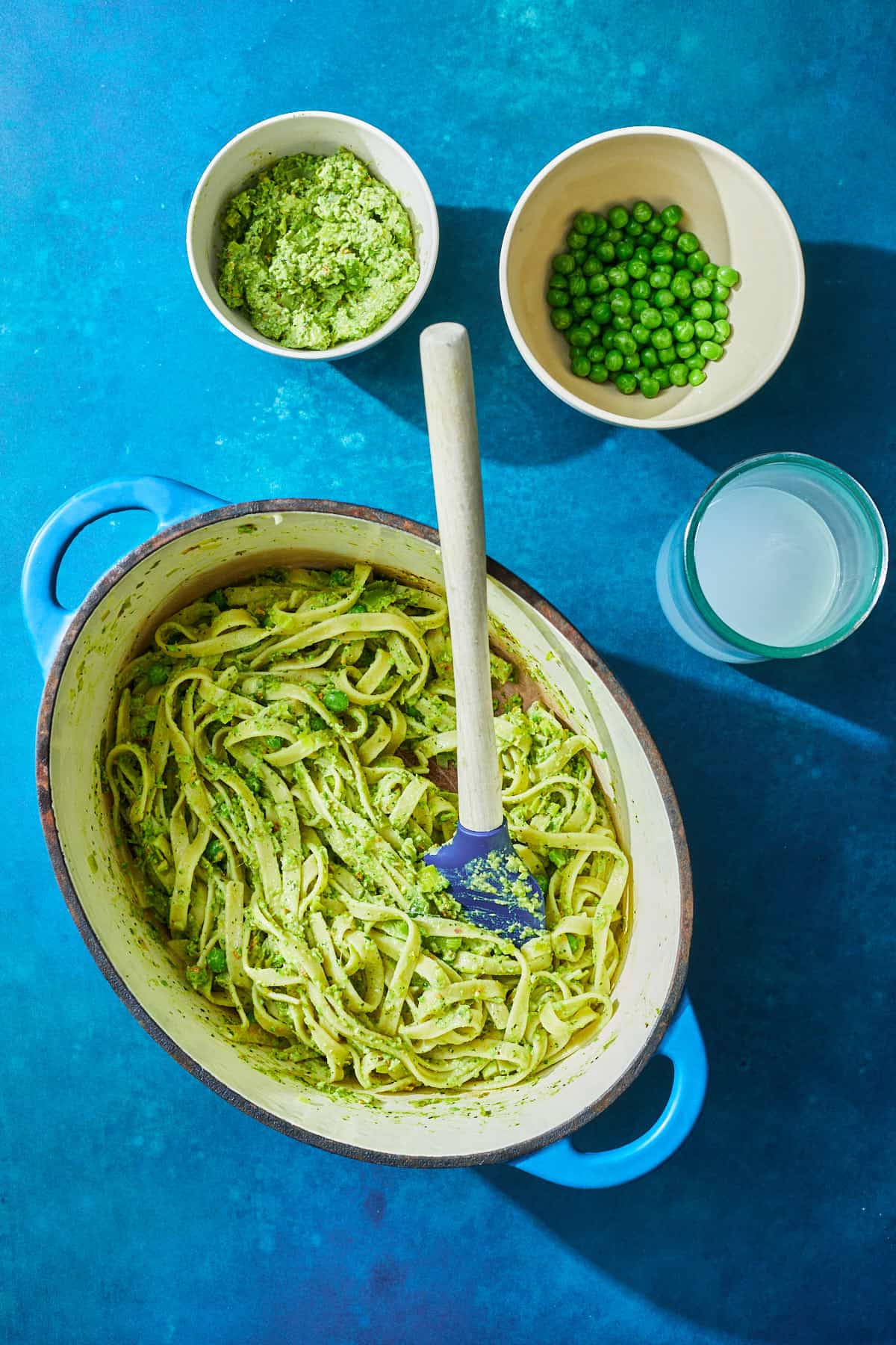 pasta in pot being tossed with pea sauce