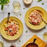 yellow dishes with penne and rum sauce with parmesan cheese and basil