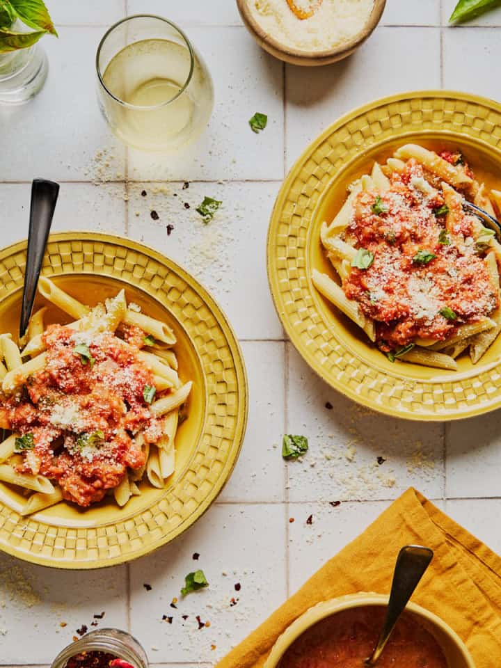 yellow dishes with penne and rum sauce with parmesan cheese and basil