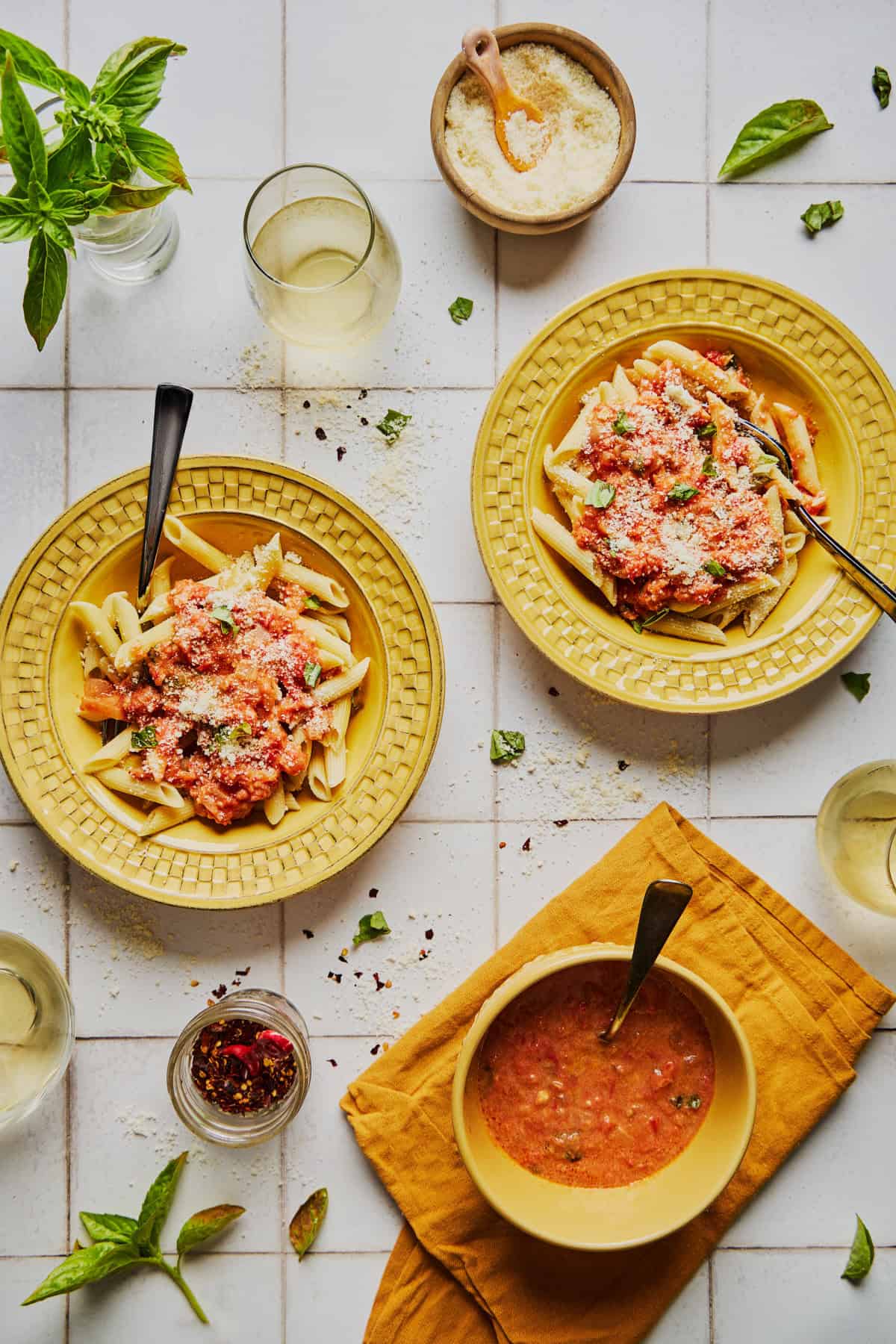 dishes of penne with rum sauce with cheese and wine