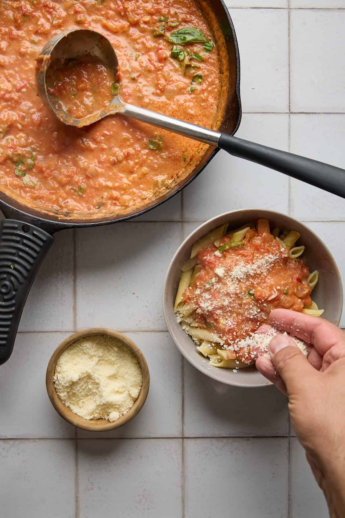a bowl of pasta with rum and tomatoes and cheese