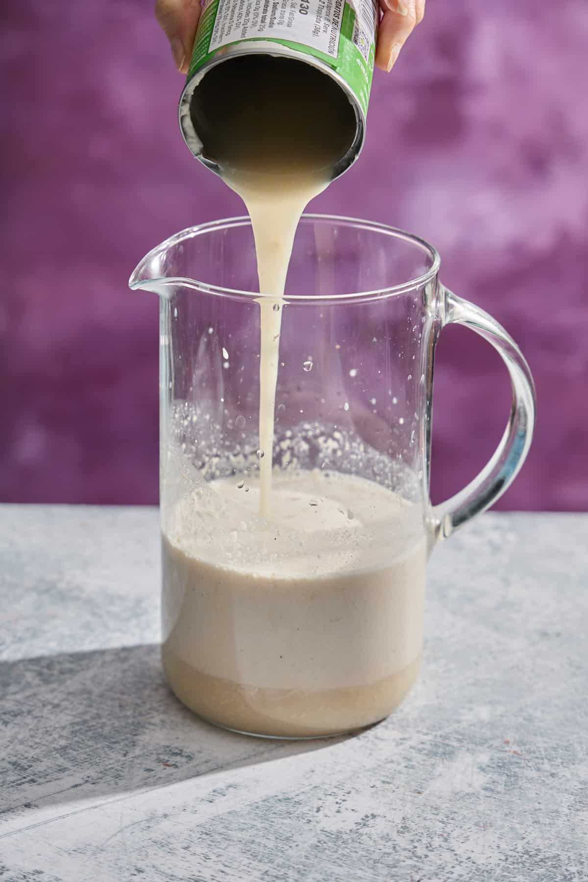 coconut condensed milk being poured into the pitcher