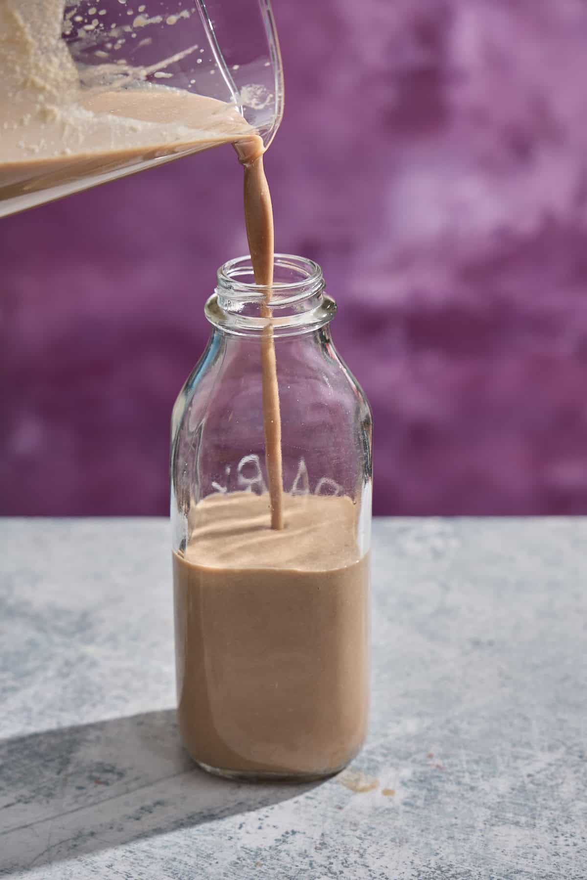 homemade Irish cream being poured into a bottle