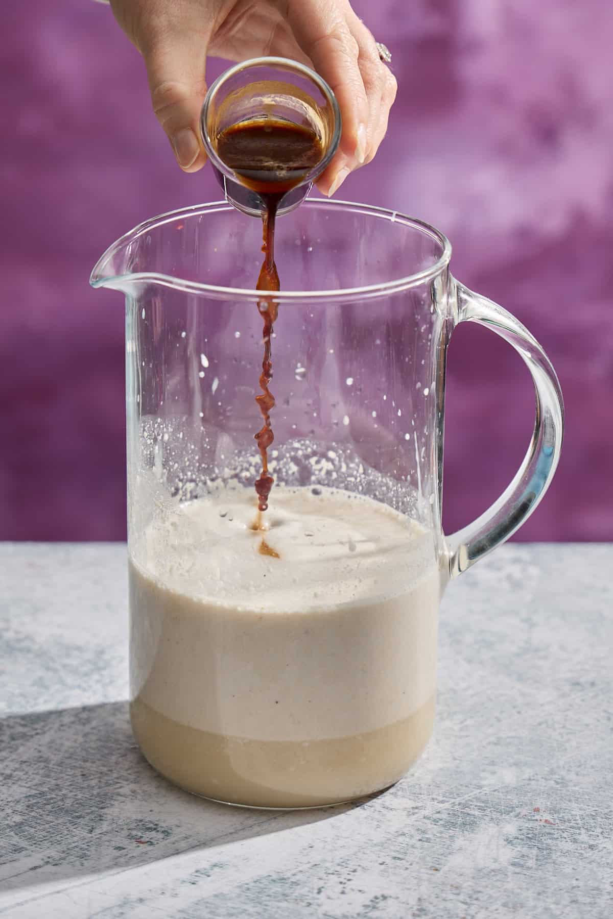 espresso being added to a pitcher
