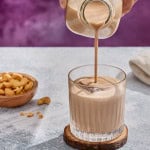 irish cream being poured into a glass with ice