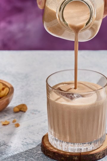 irish cream being poured into a glass with ice