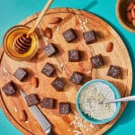 chocolates on a serving board with honey and coconut