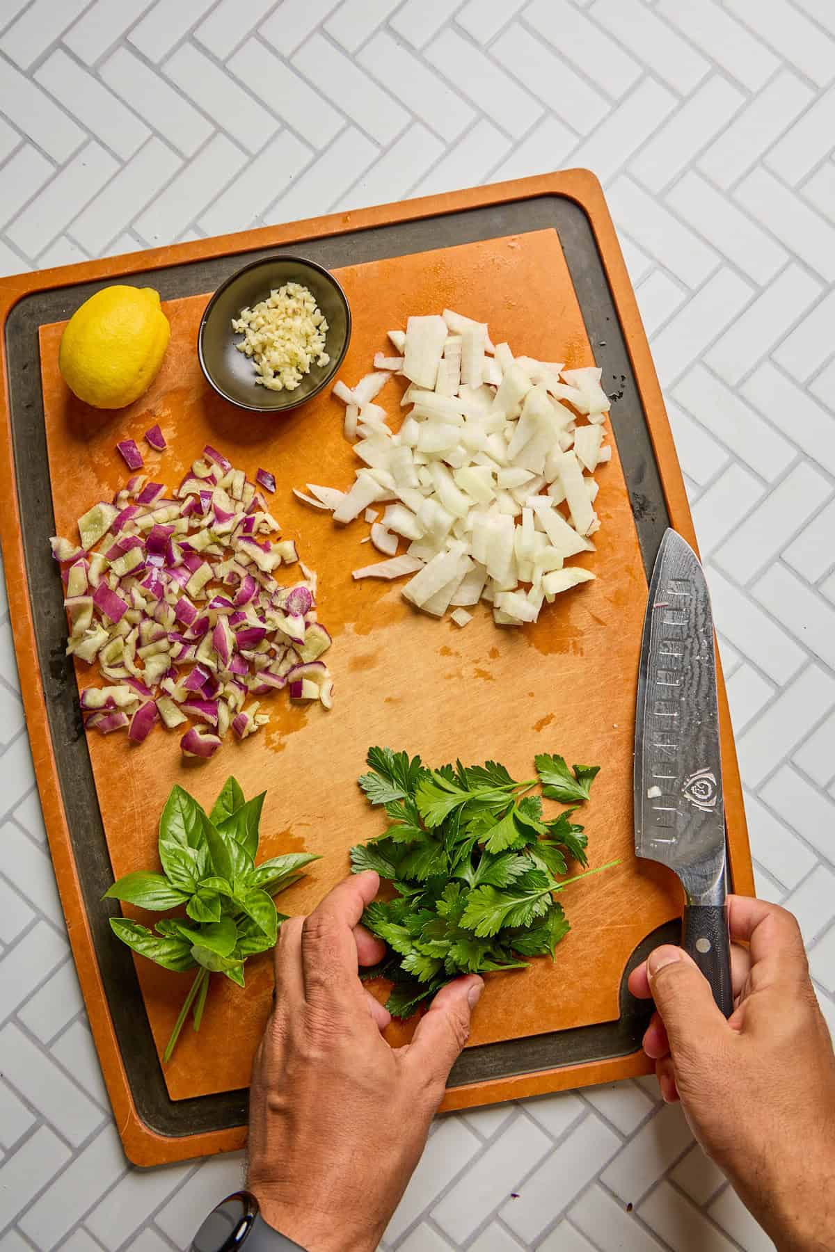 ingredients being chopped on a cutting board