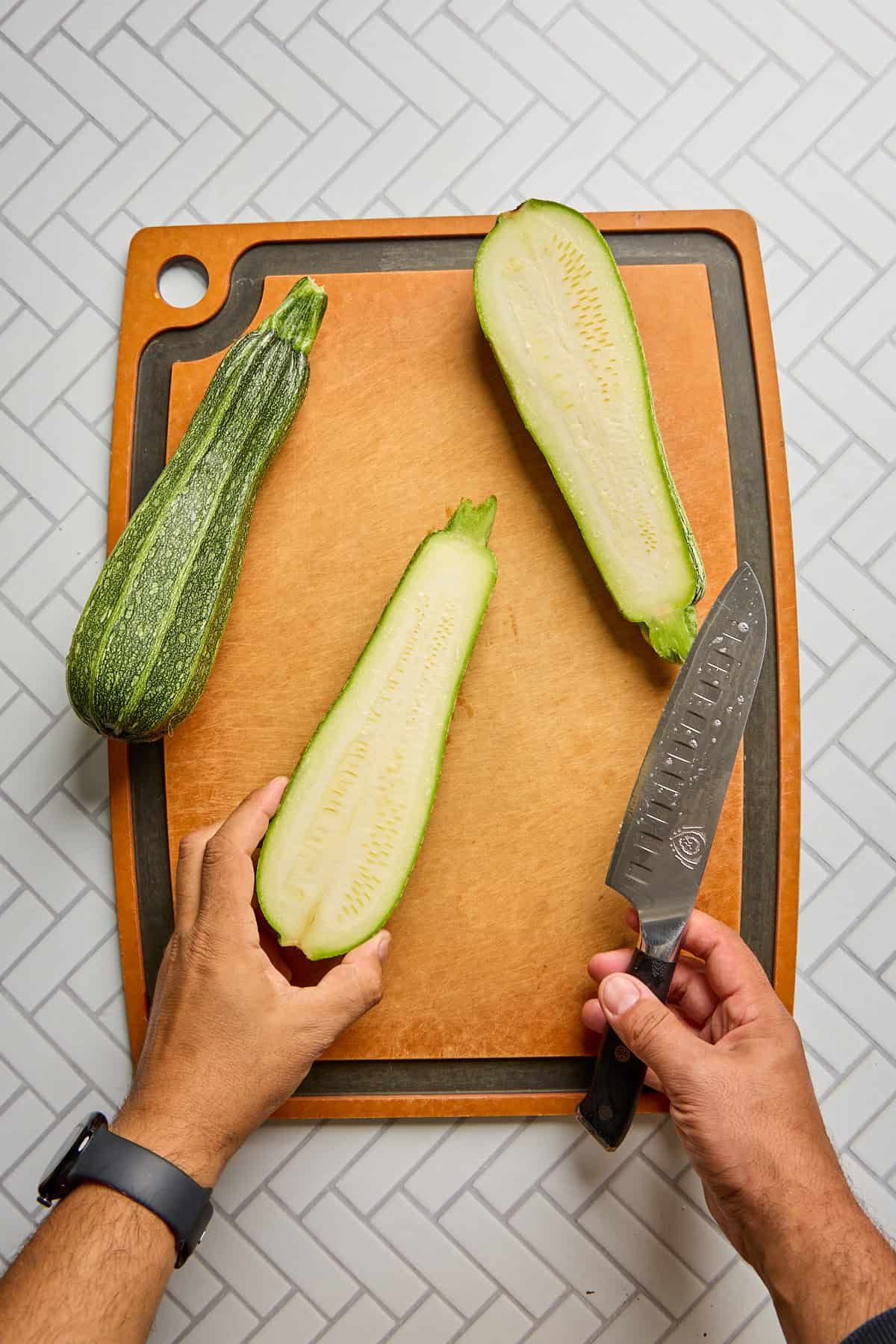 zucchini sliced in half on cutting board