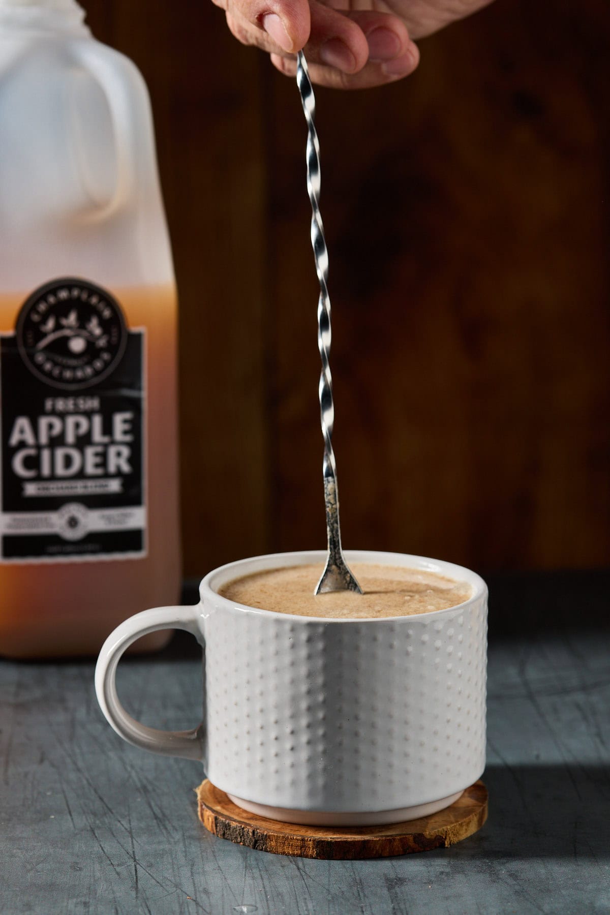 hot buttered rum being stirred in a mug