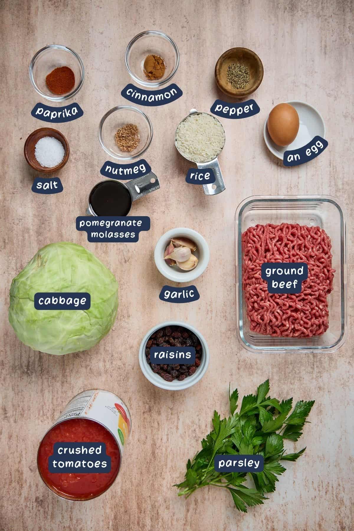 ingredients for making cabbage rolles including ground beef and tomatoes