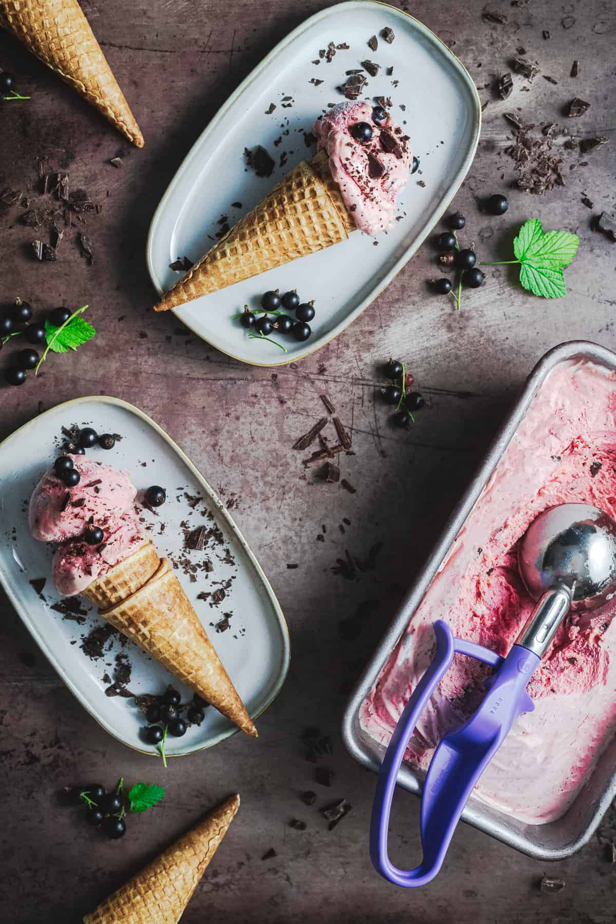 two cones of blackcurrant ice cream with chocolate 