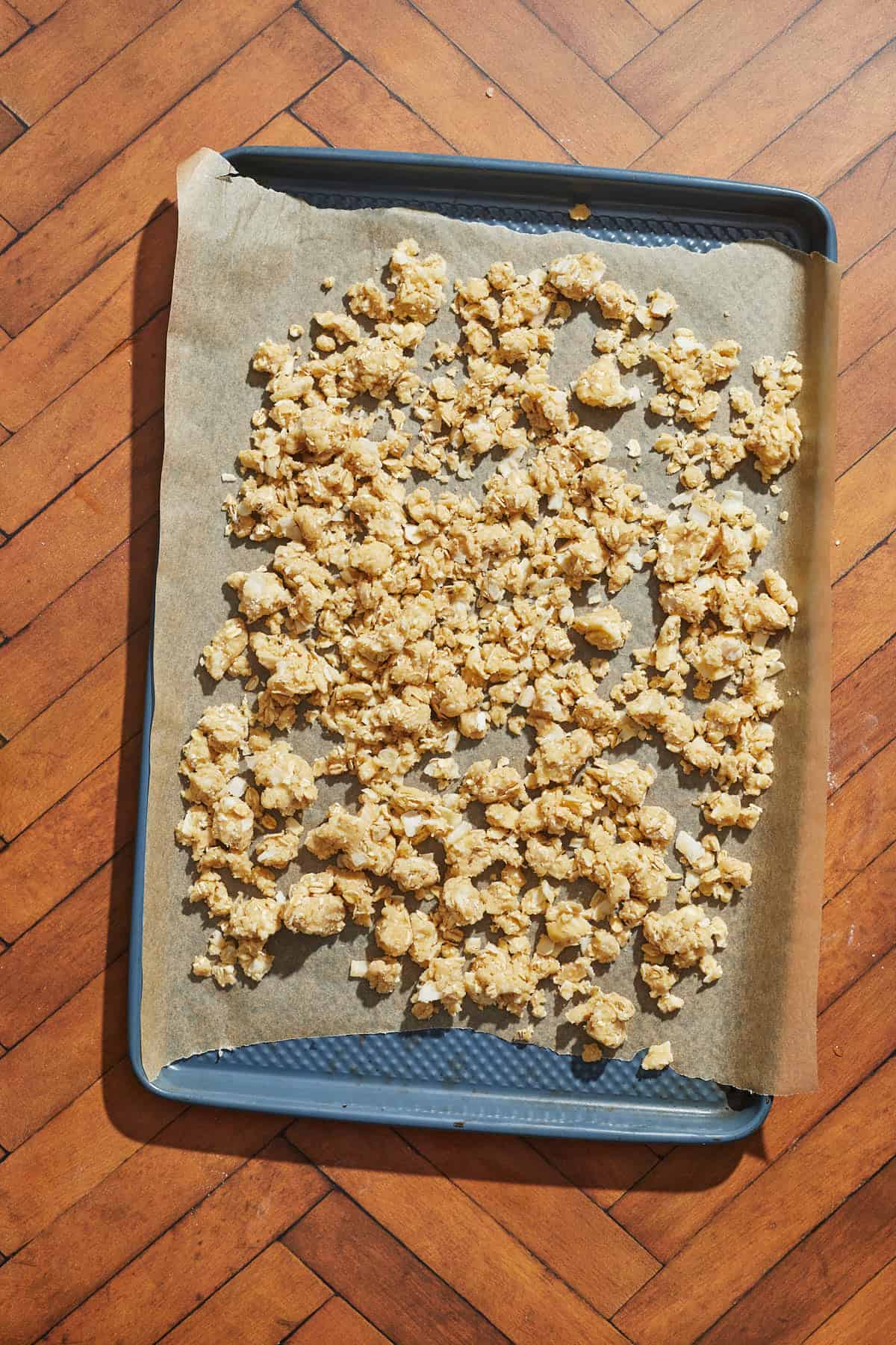the cherry crumble topping spread out on a baking sheet lined with parchment paper