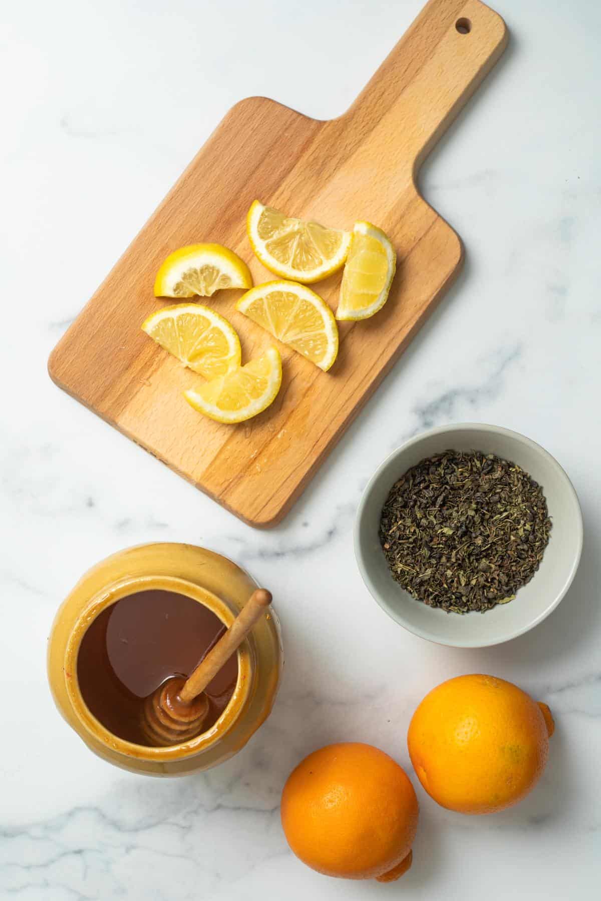 oranges, mint tea, lemon slices and honey for the tea