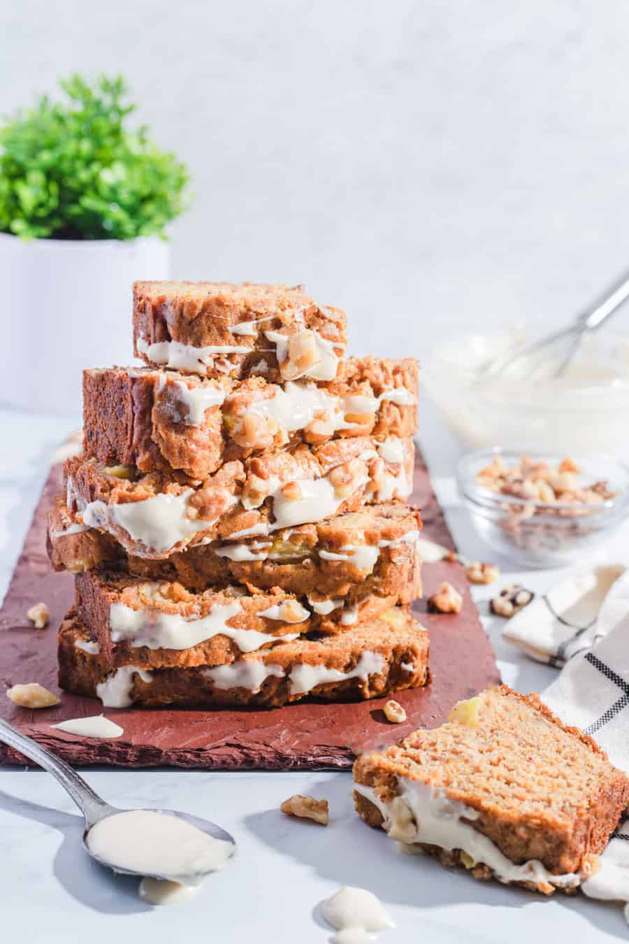 date carrot cake stacked with icing and walnuts