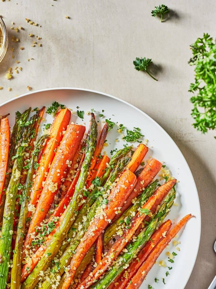 plate of roasted asparagus and carrots with breadcrumbs and parsley