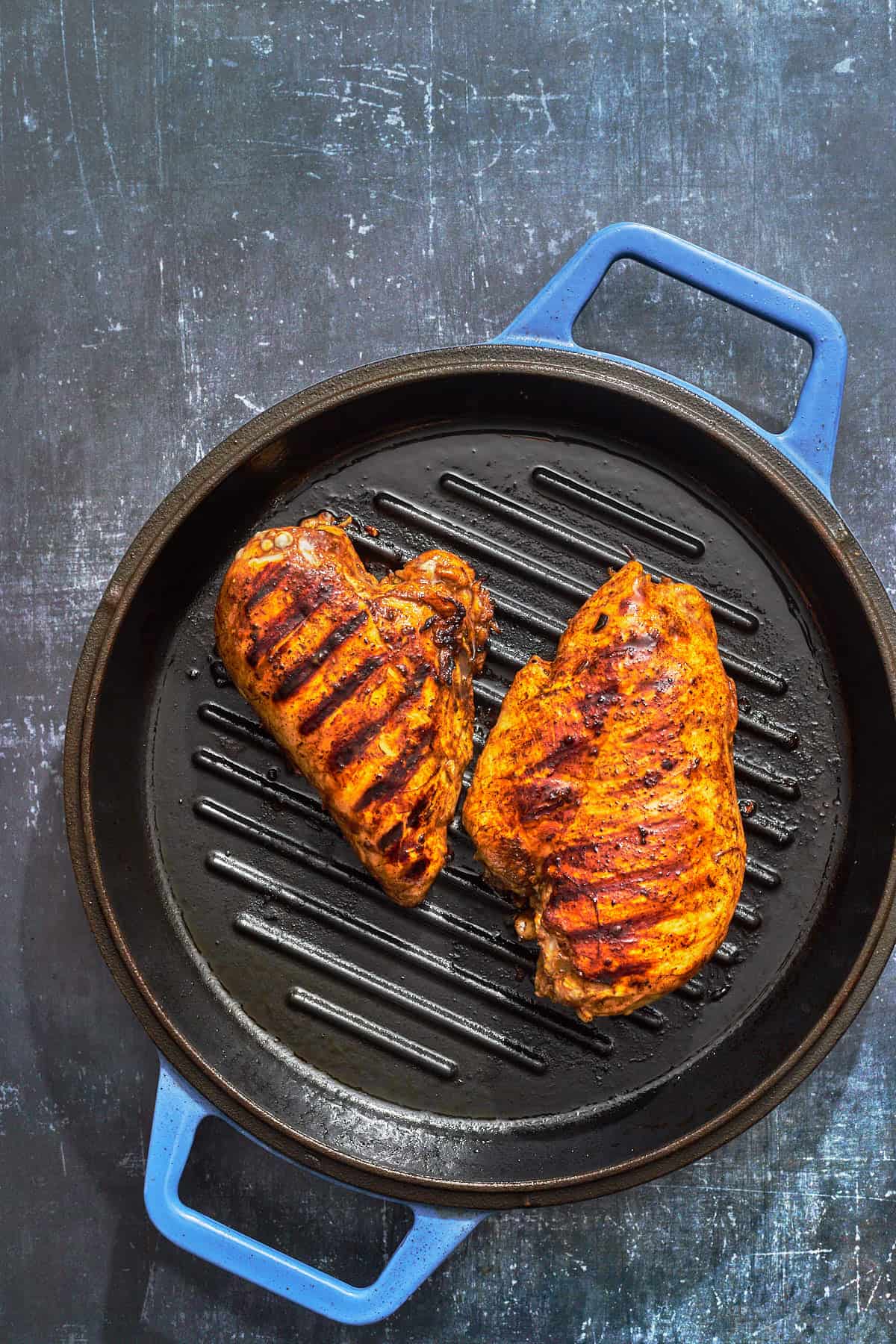 chicken breasts grilling in a grill pan