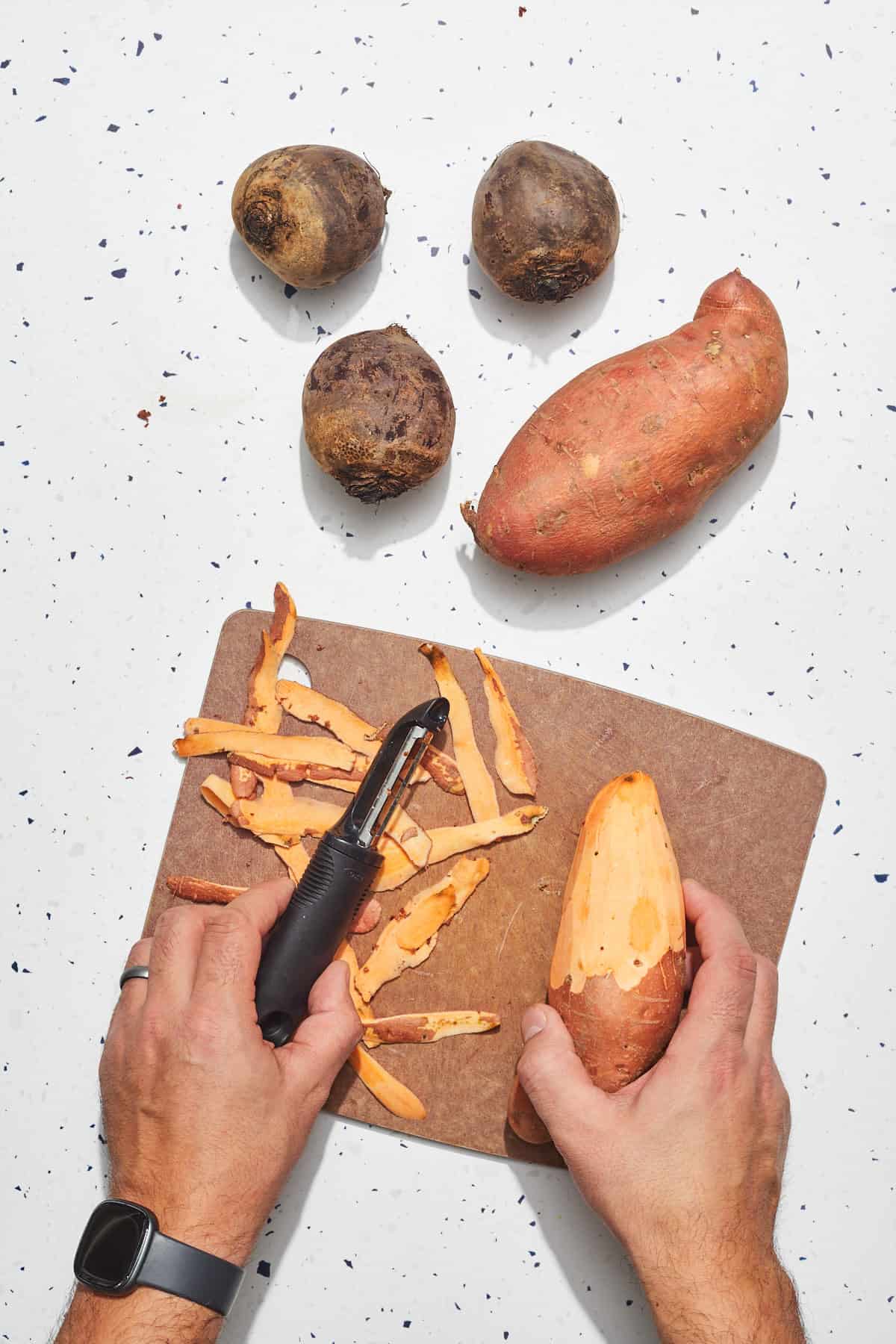 sweet potato and beet being peeled
