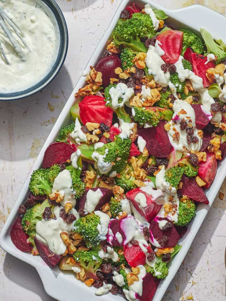 a dish of beet broccoli salad with yogurt dressing