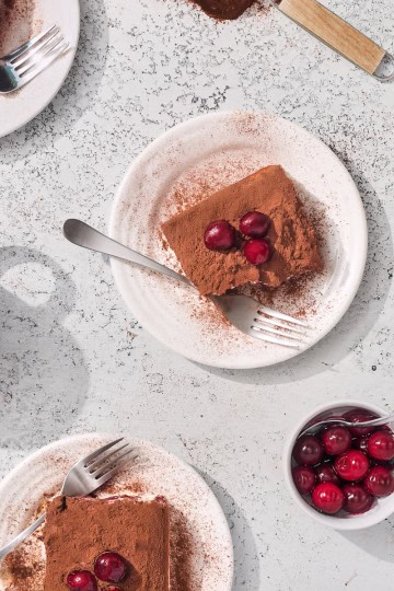 plates of tiramisu topped with cherries