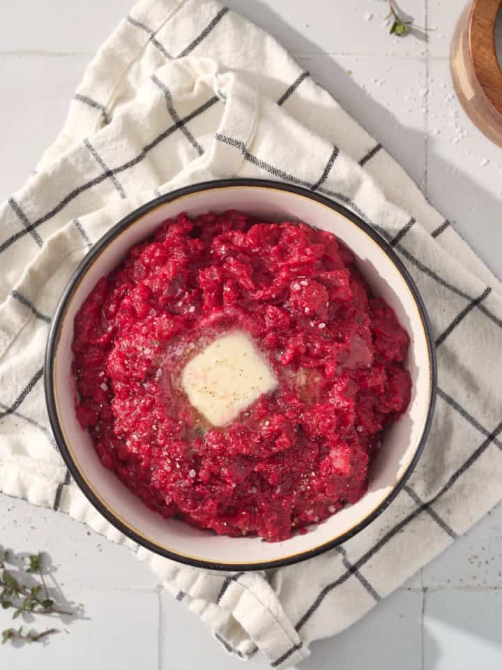 a bowl of mashed beets with butter and thyme