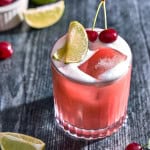 a glass with cherry whiskey sour