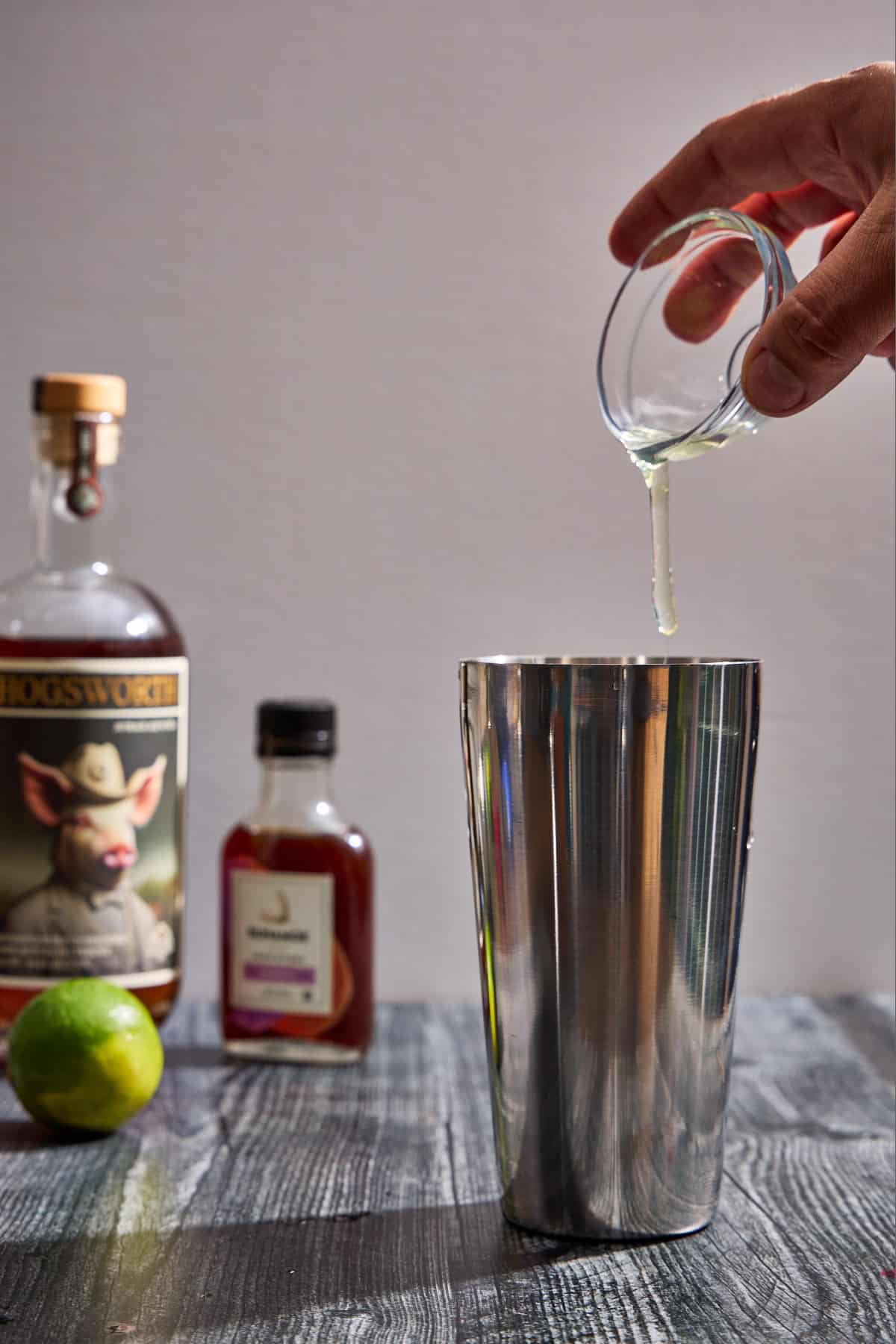 egg white being added to cocktail shaker