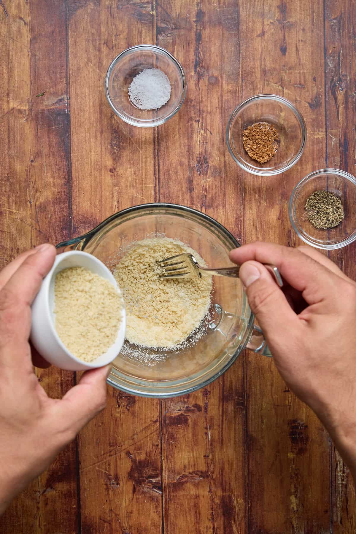 breadcrumbs and parmesan being mixed in a bowl