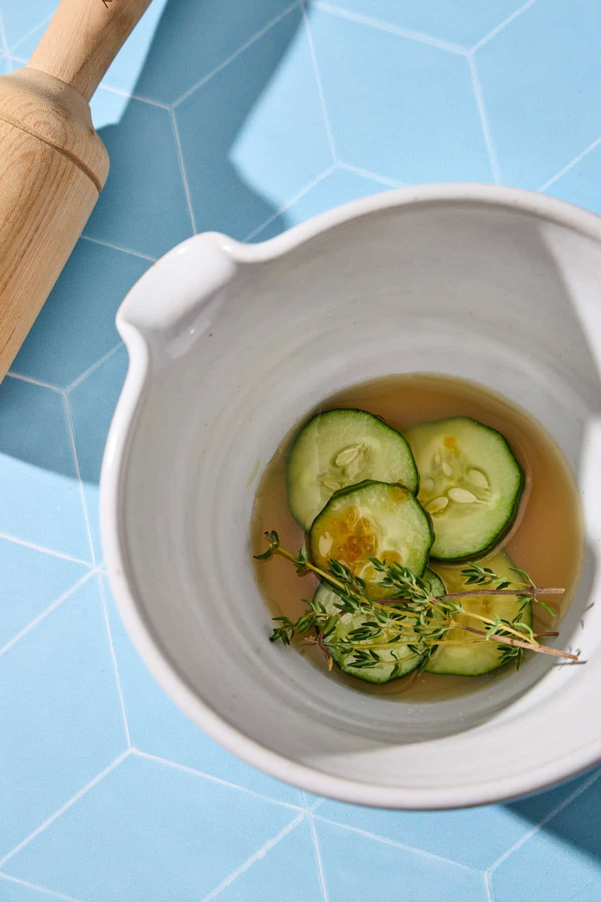 cucumber, lime juice, and maple syrup in a mortar for muddling