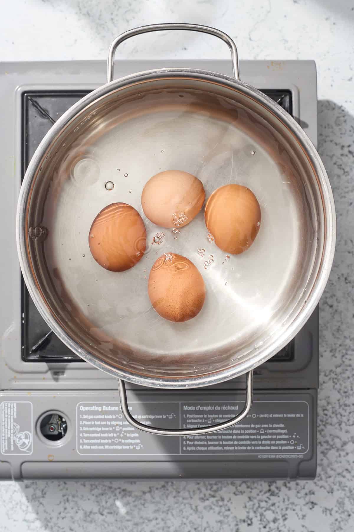 eggs boiling in a pot for the salad
