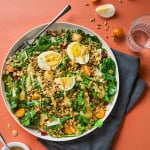 a plate of kale and lentil salad with barley and eggs