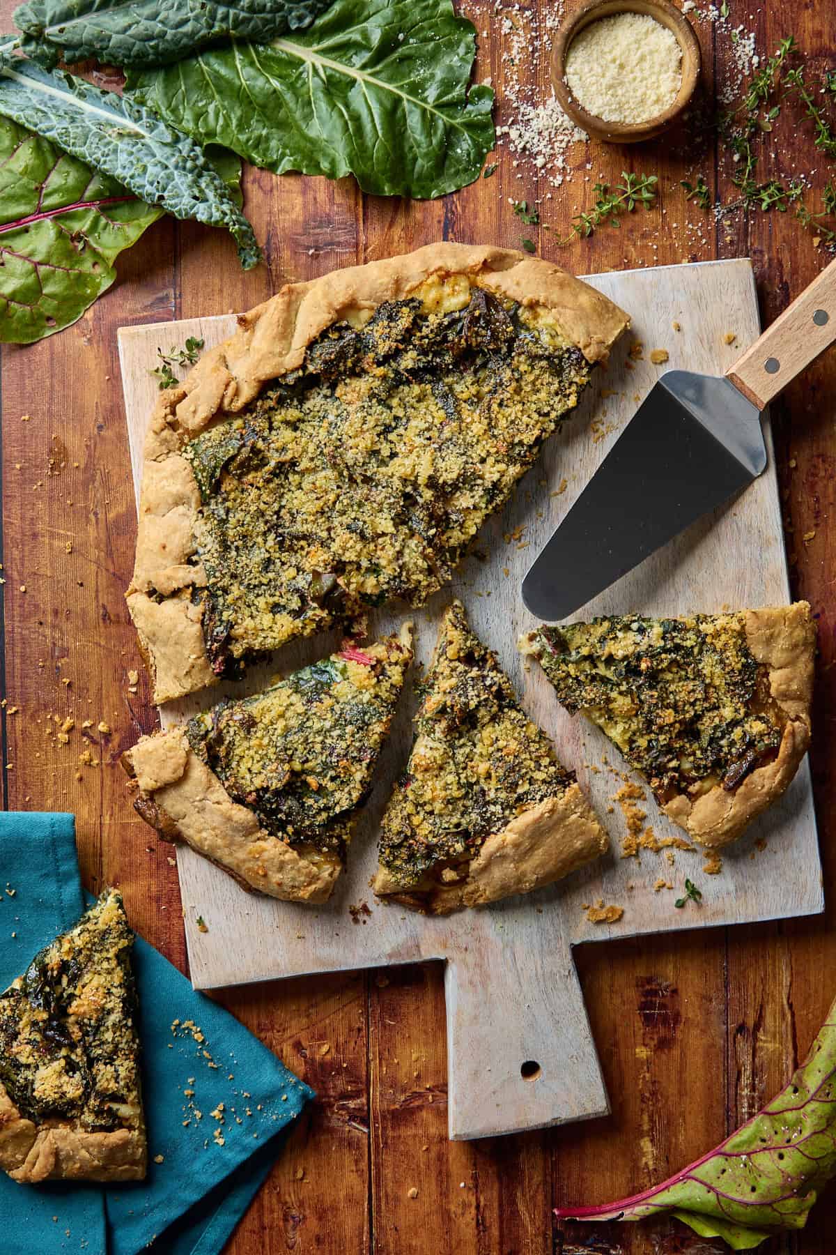 a baked kale and swiss chard galette on a cutting board