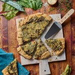 a galette of swiss chard and kale leaves baked on a cutting board