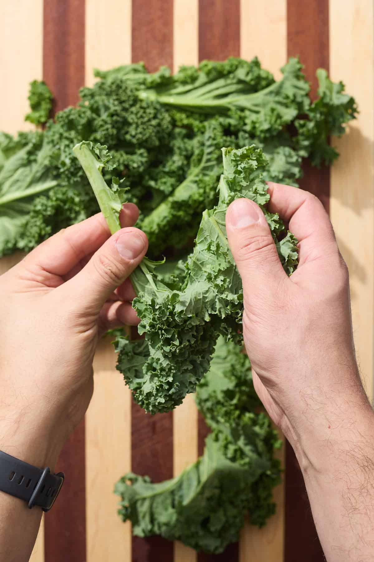 ribs of kale being removed from leaves