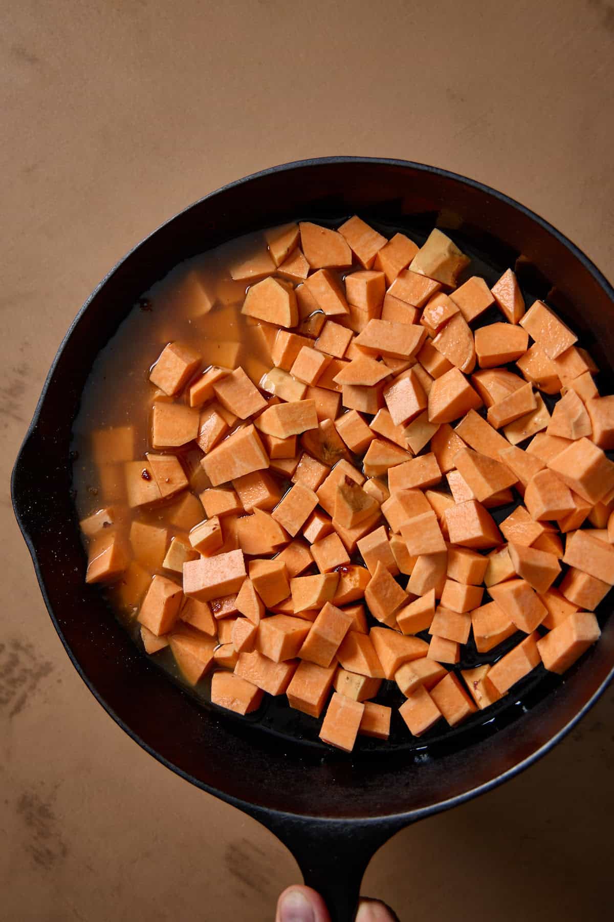 sweet potatoes in a pan with broth