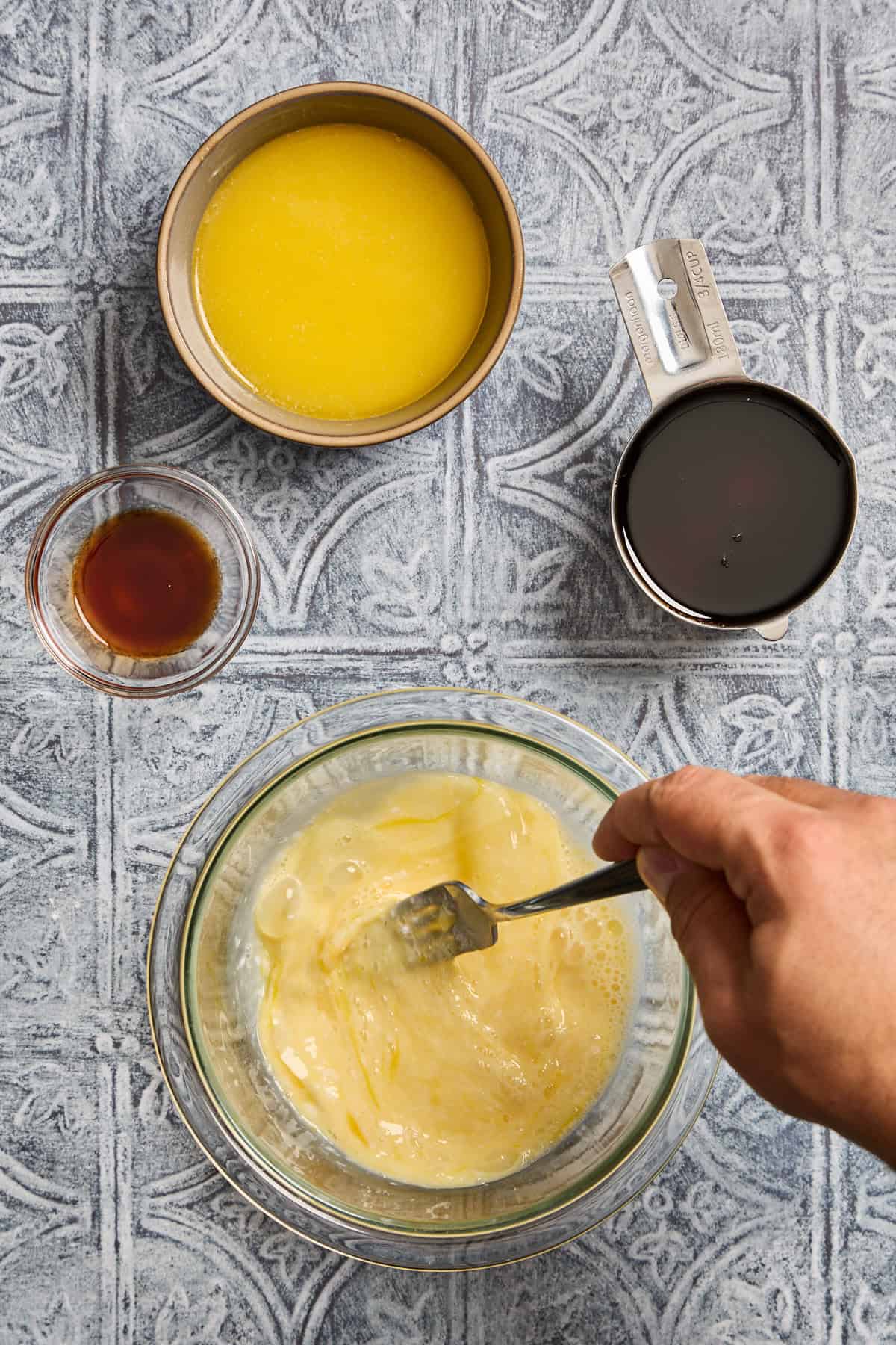 eggs and butter being whisked in a bowl
