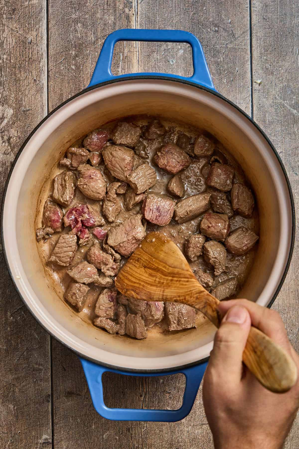 stew beef browning in a dutch oven