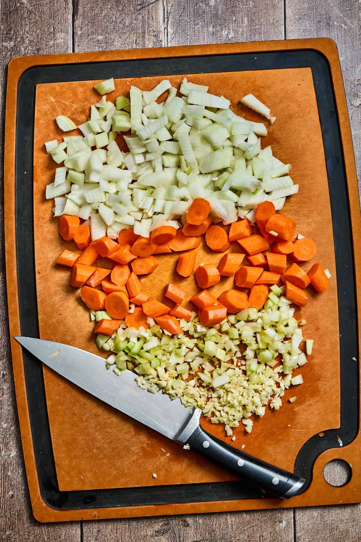 vegetables being chopped on a cutting board for the stew