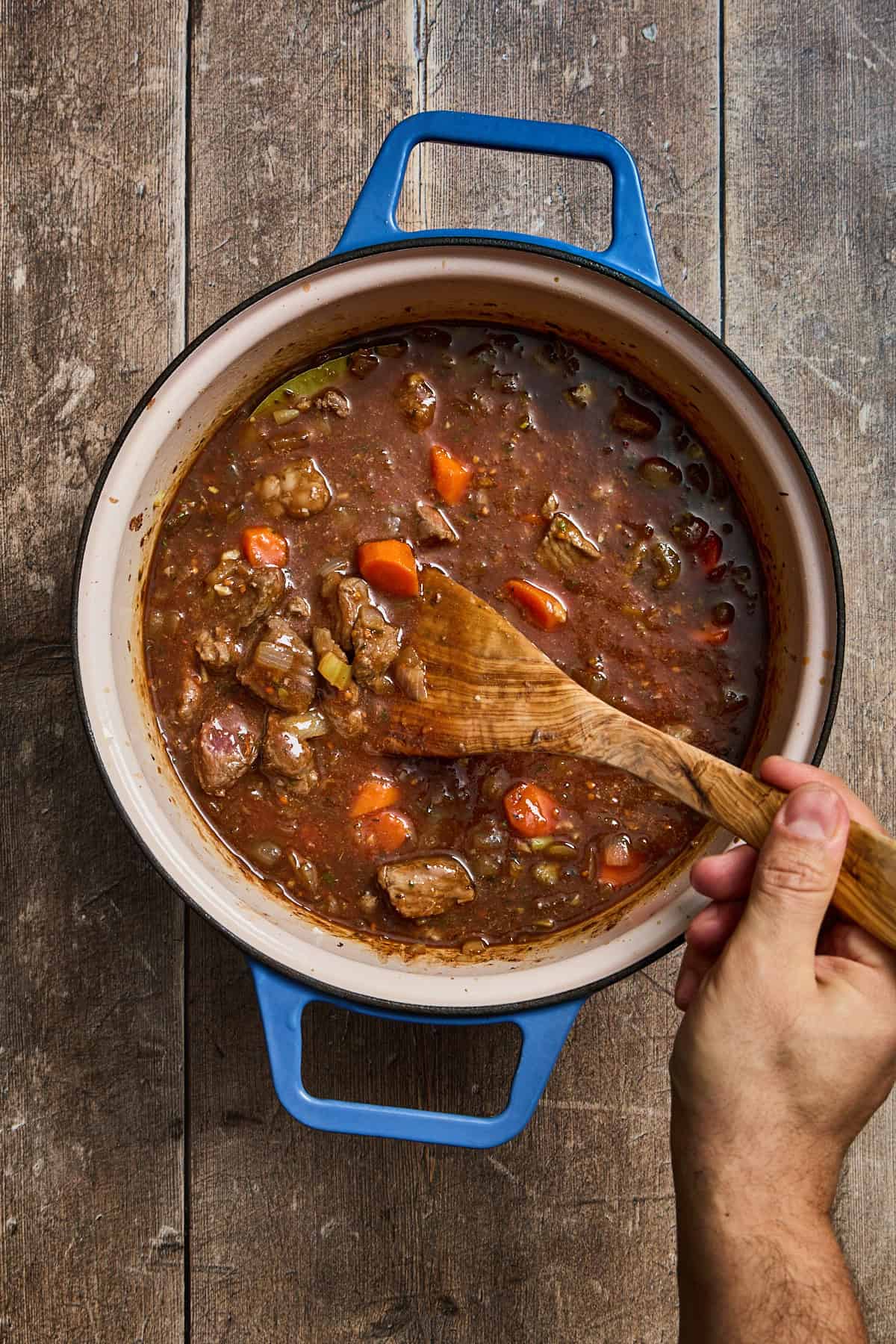 beef stew being cooked and stirred