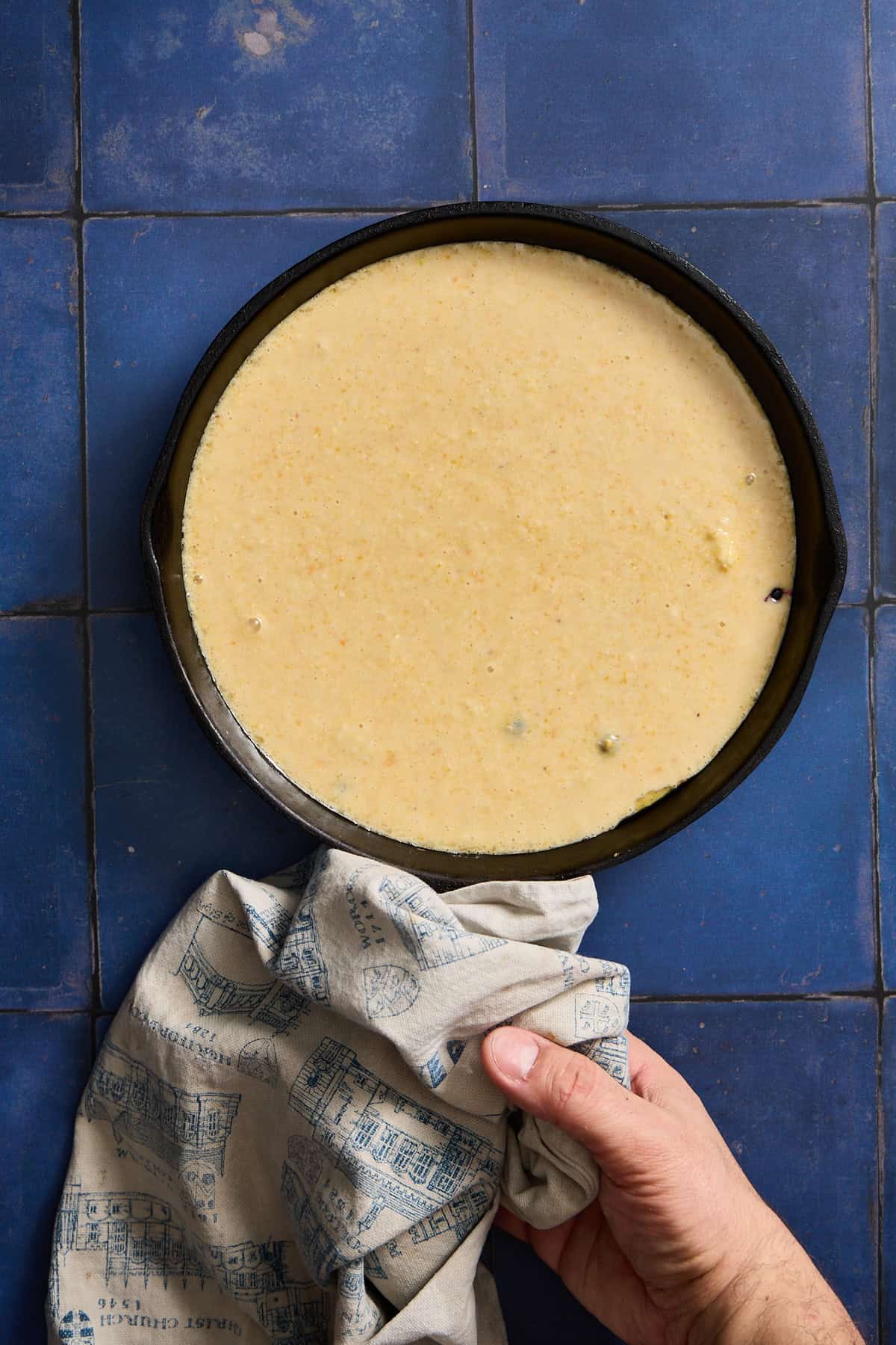 pan of cake batter on counter with towel
