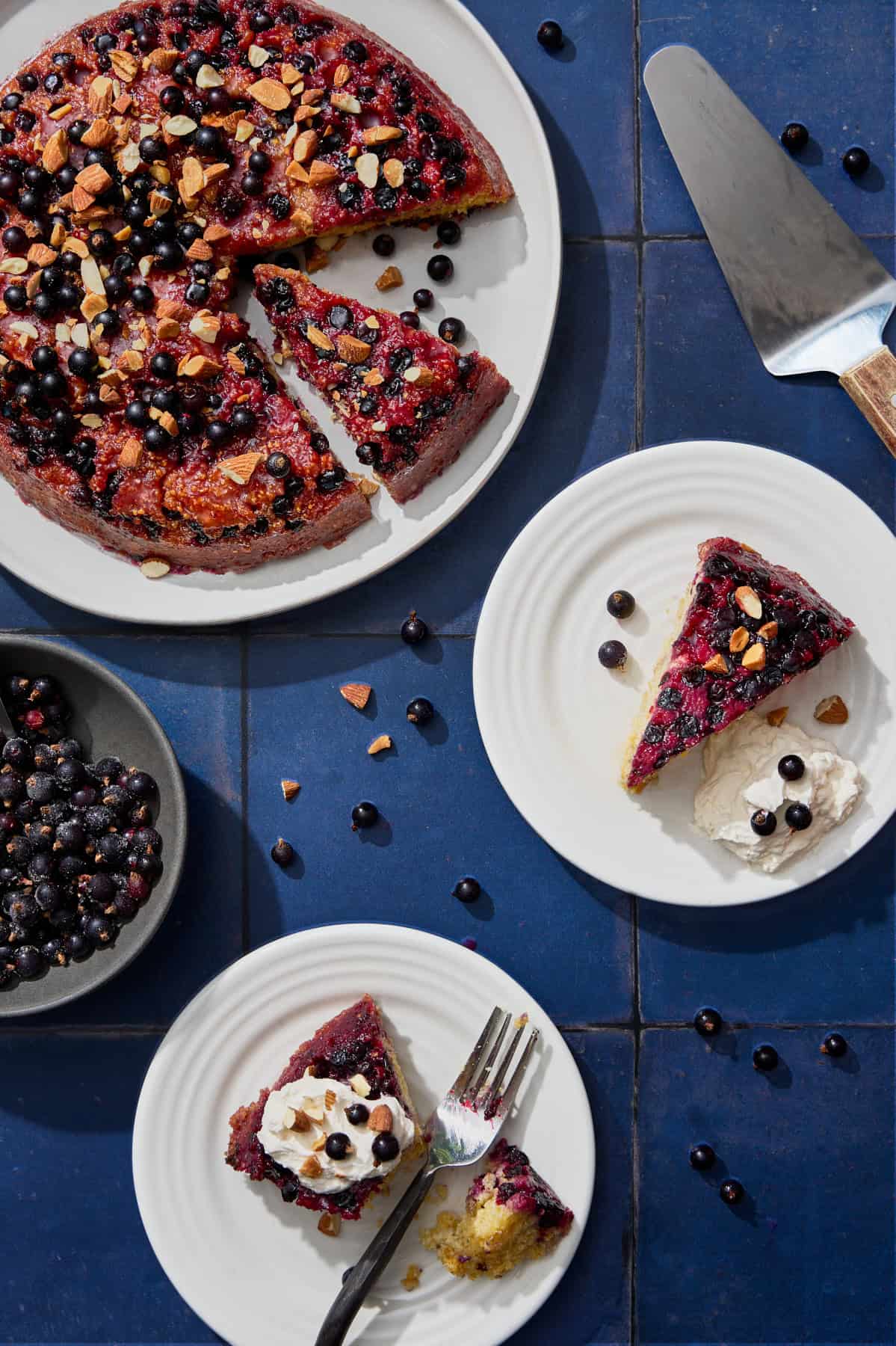 plates of blackcurrant cake with almonds