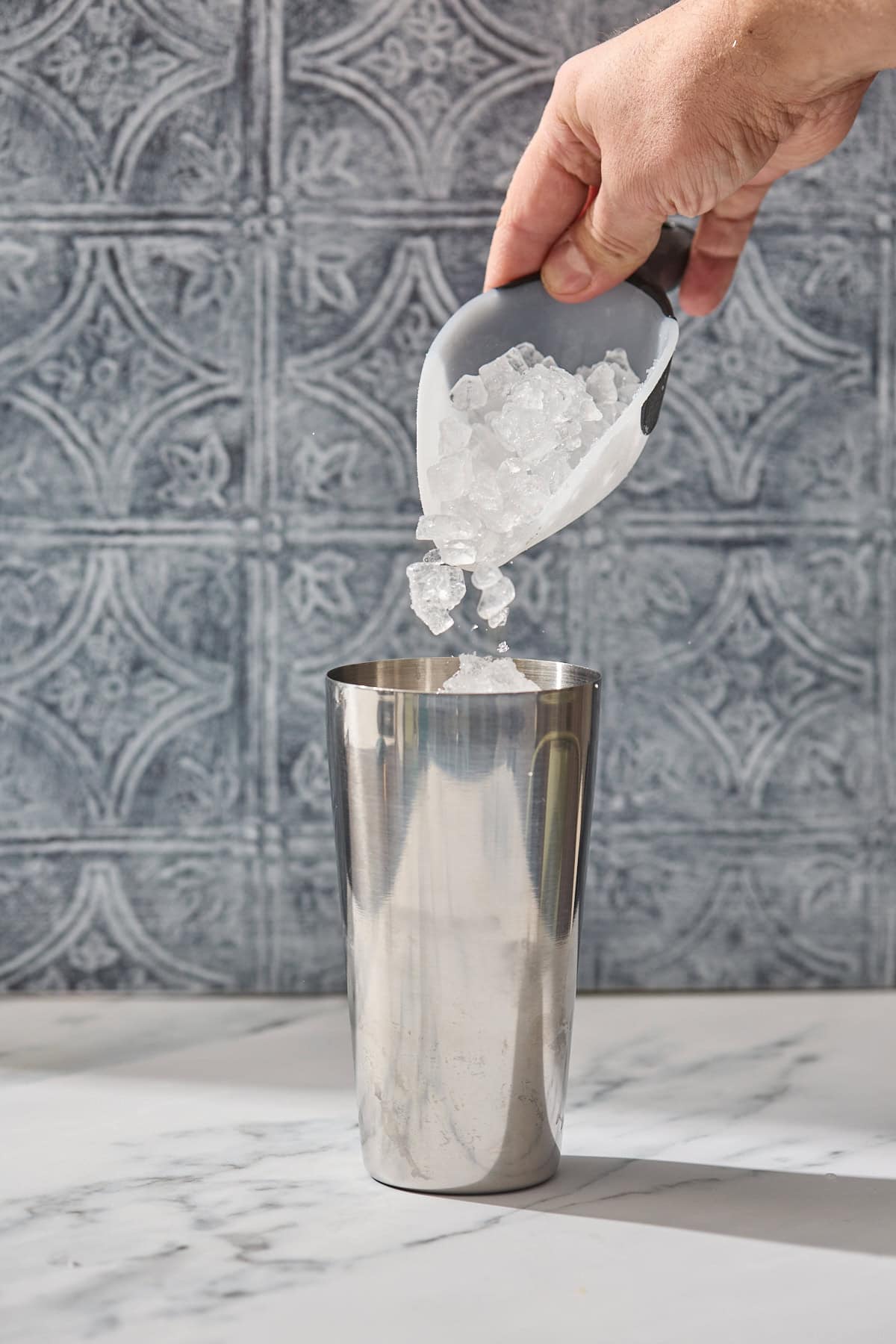 ice being poured into a shaker