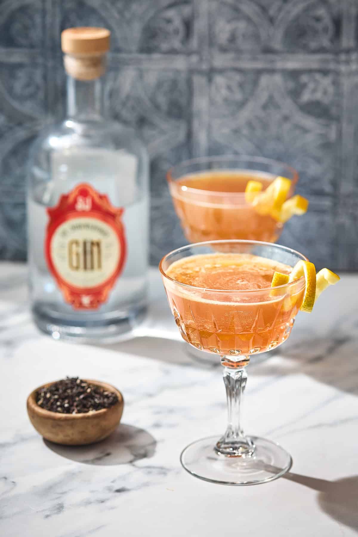 glasses of earl grey cocktail with tea and a bottle of gin